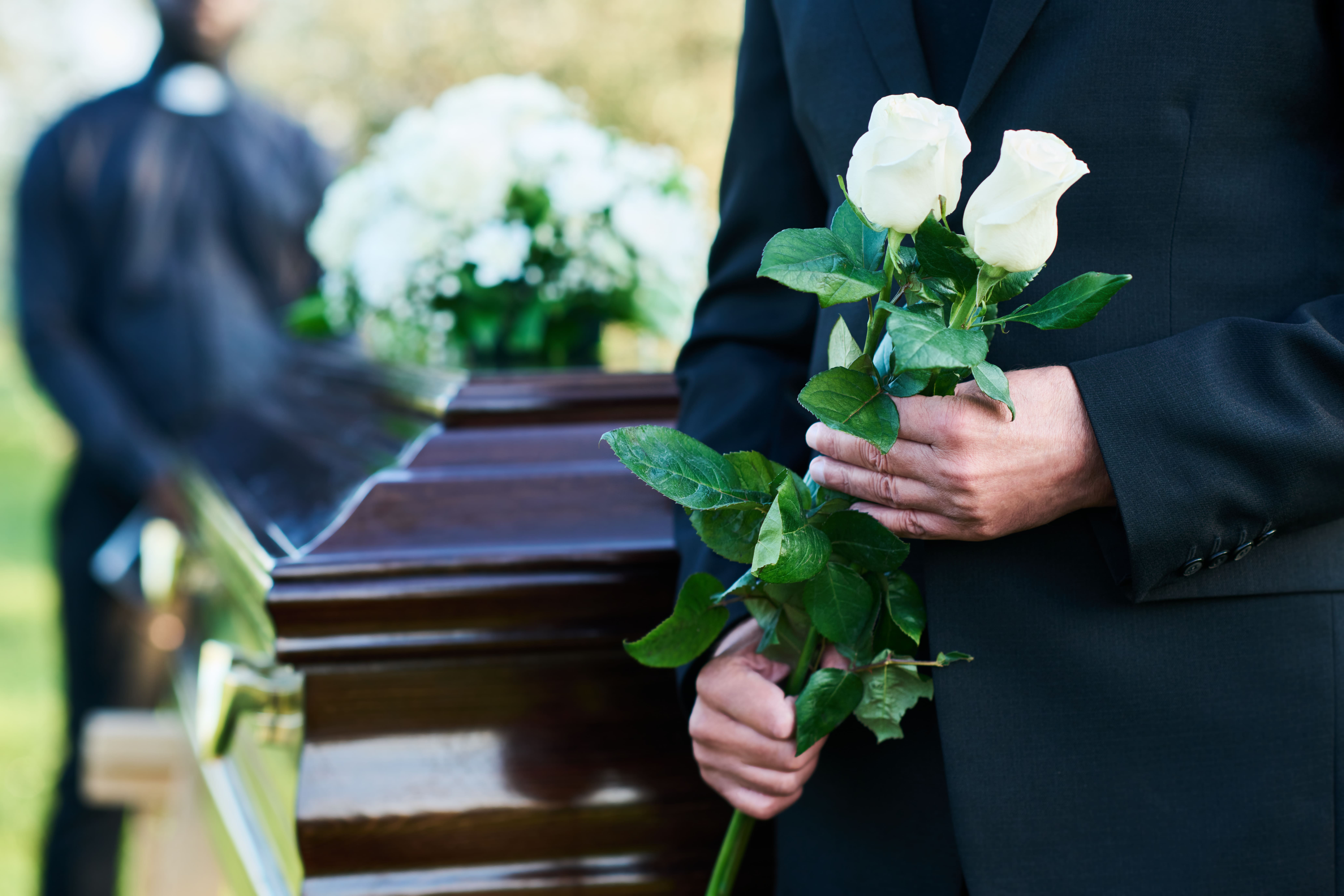 closeup-matue-man-black-suit-holding-two-fresh-white-roses (1).jpg